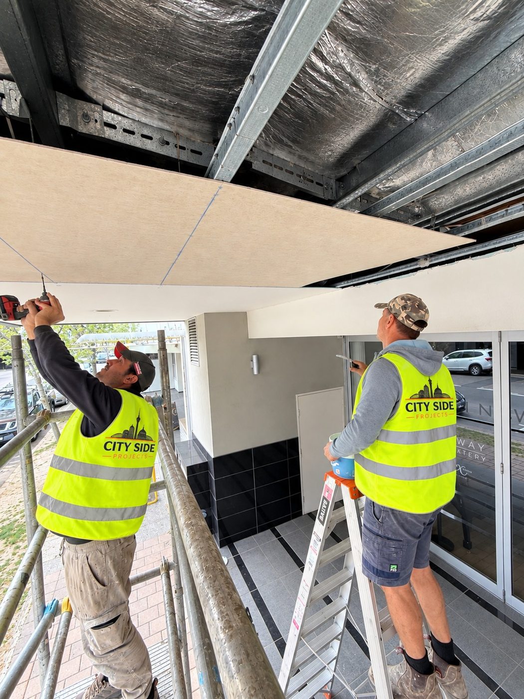 City Side team replacing awning soffit from mobile scaffold
