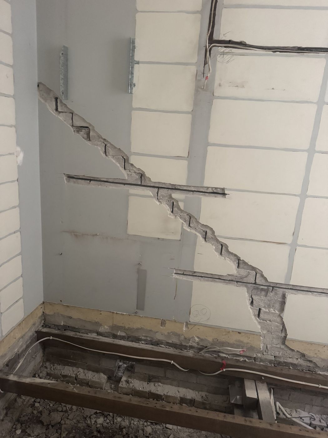 Cracked internal brick wall opened up