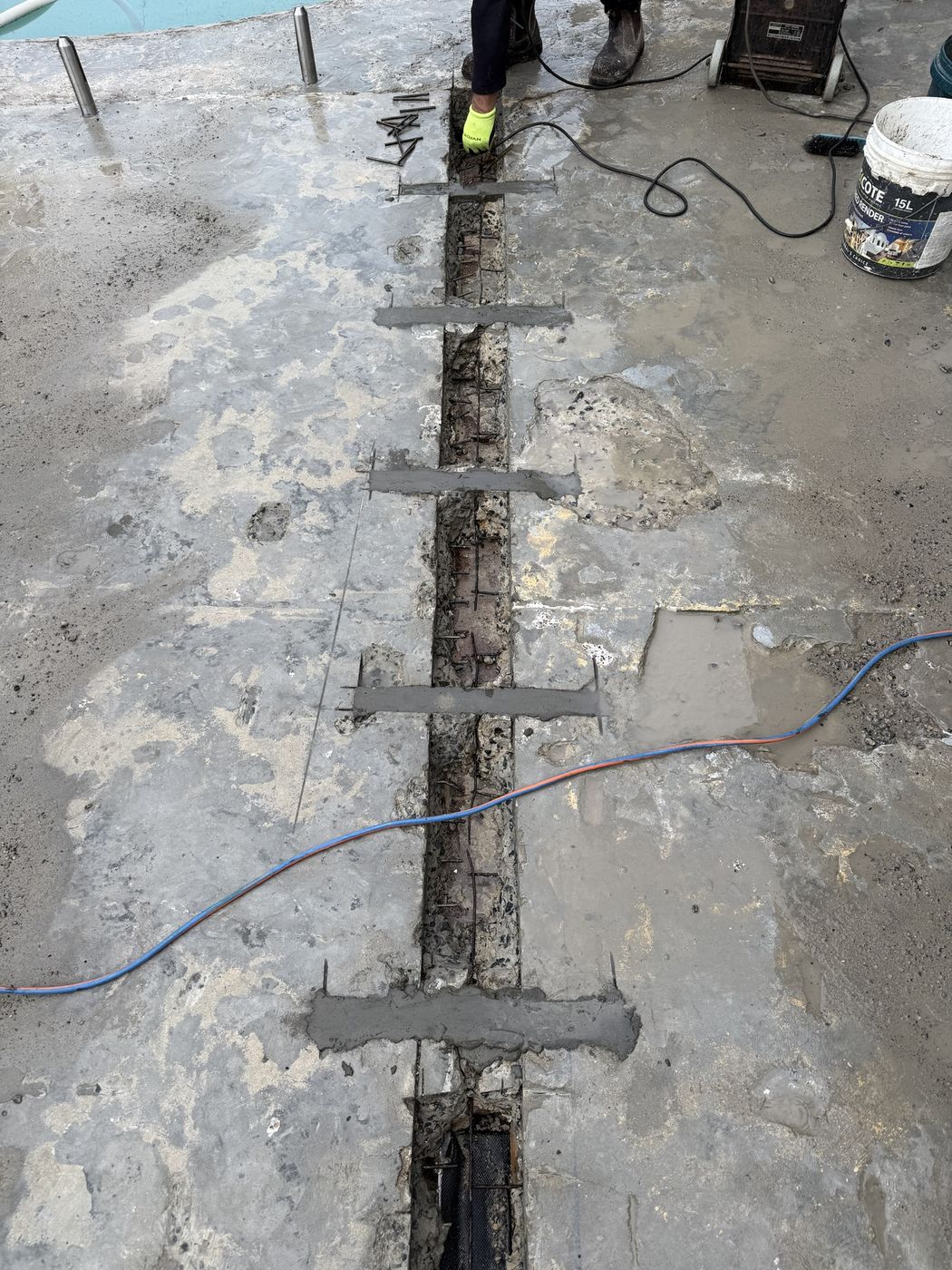 Exposed reinforcement cleaned and treated