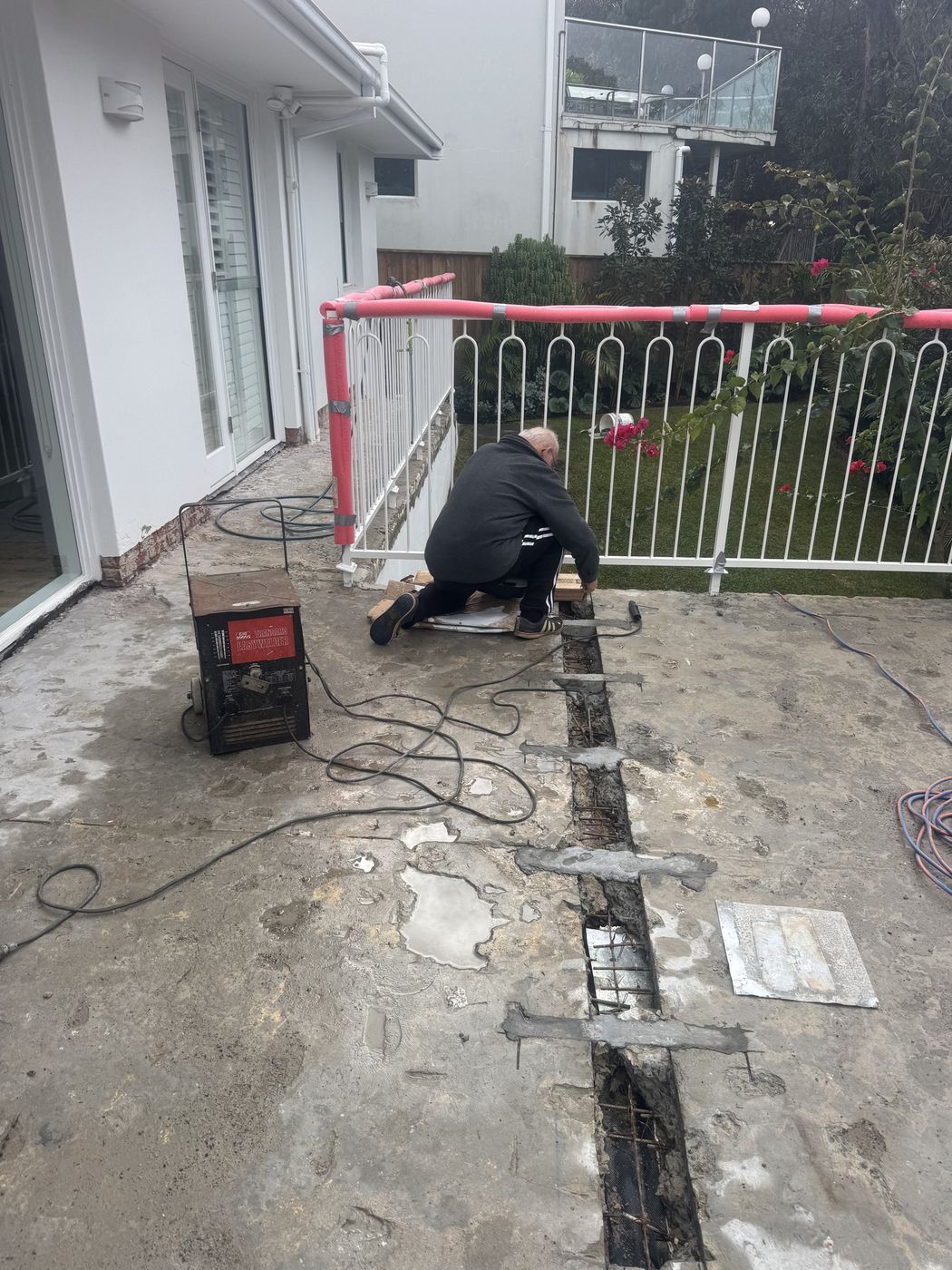 Slab joint repair along pool fence