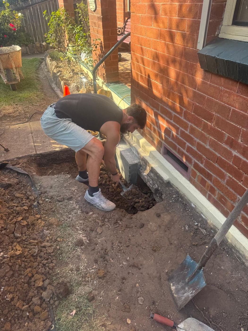 Footing excavation beside brick house